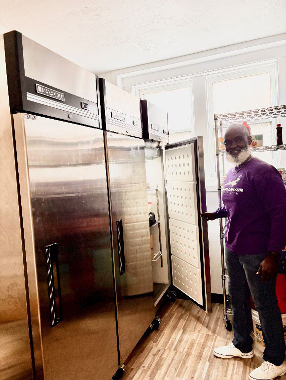 volunteer with fridge at food pantry